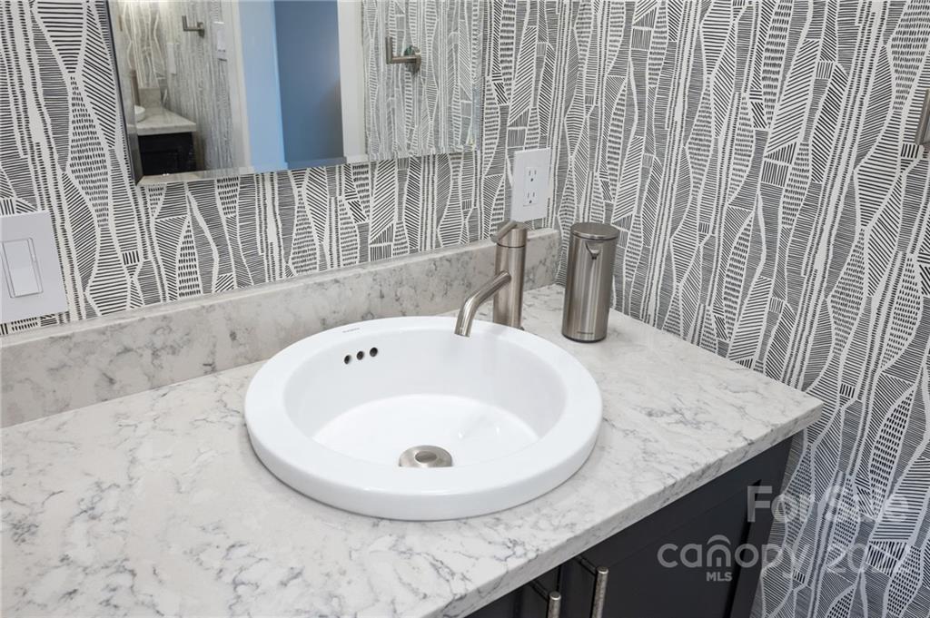 9 Kenilworth Road Asheville, NC 28803 - Photo 19 of 33 a bathroom with a granite countertop sink and a mirror