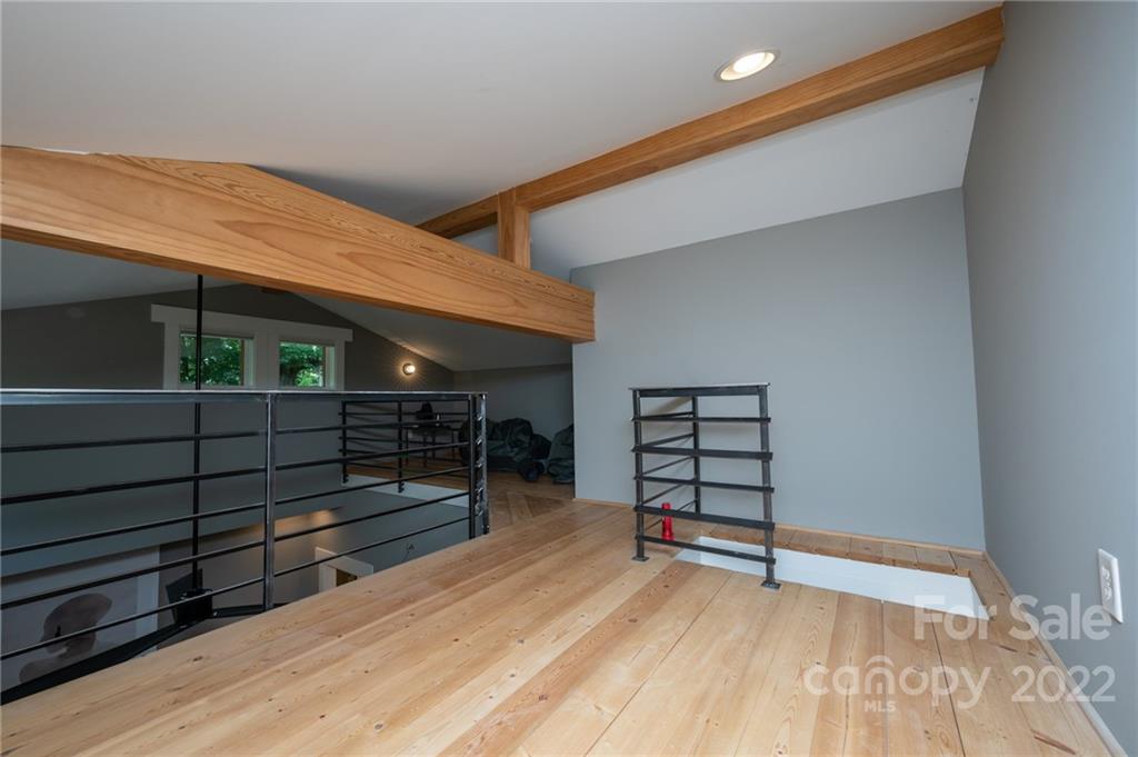 9 Kenilworth Road Asheville, NC 28803 - Photo 23 of 33 a view of a room with wooden floor and a ceiling fan
