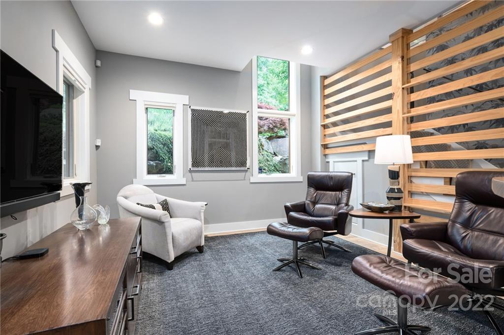 9 Kenilworth Road Asheville, NC 28803 - Photo 25 of 33 a living room with furniture and a flat screen tv