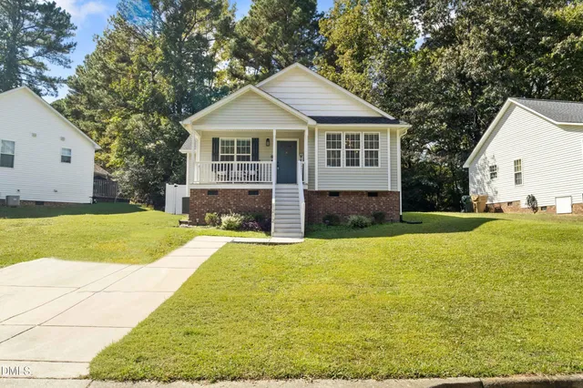 a front view of a house with yard and garage