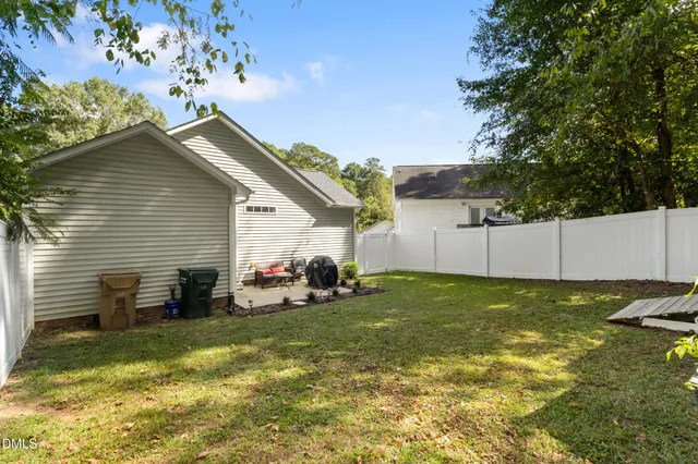 a view of a backyard with plants and a patio