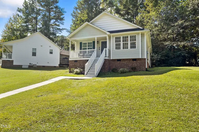 a view of a house with a yard and swimming pool