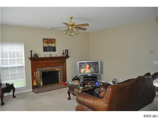 752 West Cheval Drive Fort Mill, SC 29708 - Photo 2 of 8 a living room with furniture a fireplace and a flat screen tv