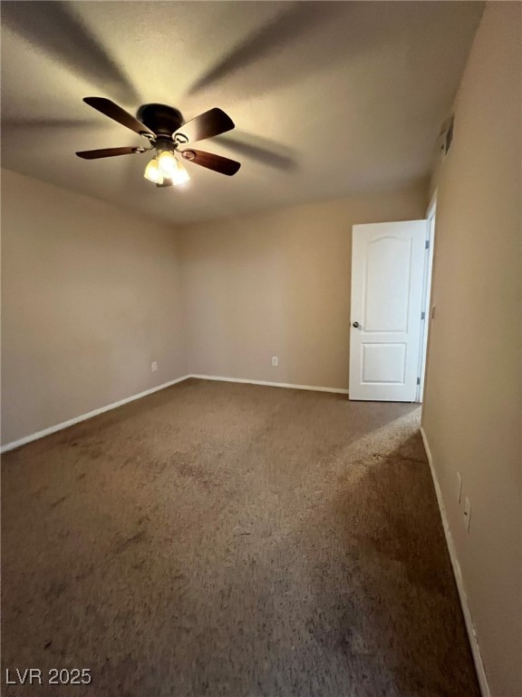 9325 West Desert Inn Road, Unit 206 Las Vegas, NV 89117 - Photo 11 of 37 Empty room with dark carpet and a ceiling fan