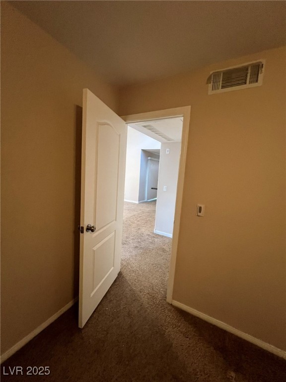 9325 West Desert Inn Road, Unit 206 Las Vegas, NV 89117 - Photo 12 of 37 Corridor featuring dark colored carpet and baseboards