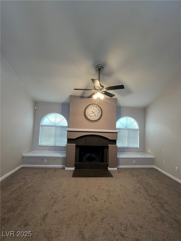 9325 West Desert Inn Road, Unit 206 Las Vegas, NV 89117 - Photo 14 of 37 Unfurnished living room with carpet, a fireplace with flush hearth, and ceiling fan