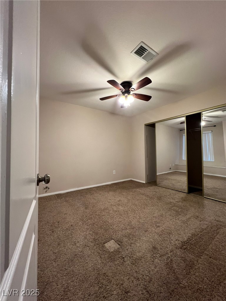 9325 West Desert Inn Road, Unit 206 Las Vegas, NV 89117 - Photo 17 of 37 Unfurnished bedroom featuring carpet floors, a closet, and a ceiling fan