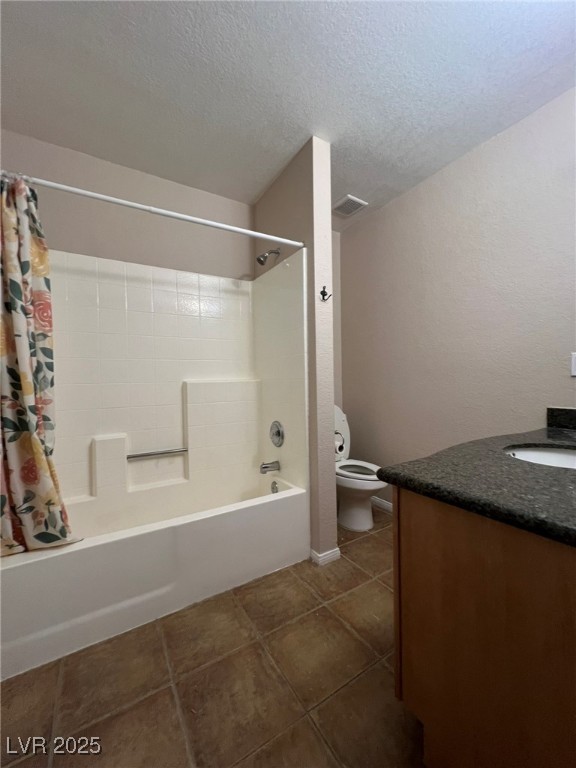 9325 West Desert Inn Road, Unit 206 Las Vegas, NV 89117 - Photo 19 of 37 Full bathroom with vanity, shower / tub combo with curtain, dark tile patterned flooring, a textured ceiling, and a textured wall