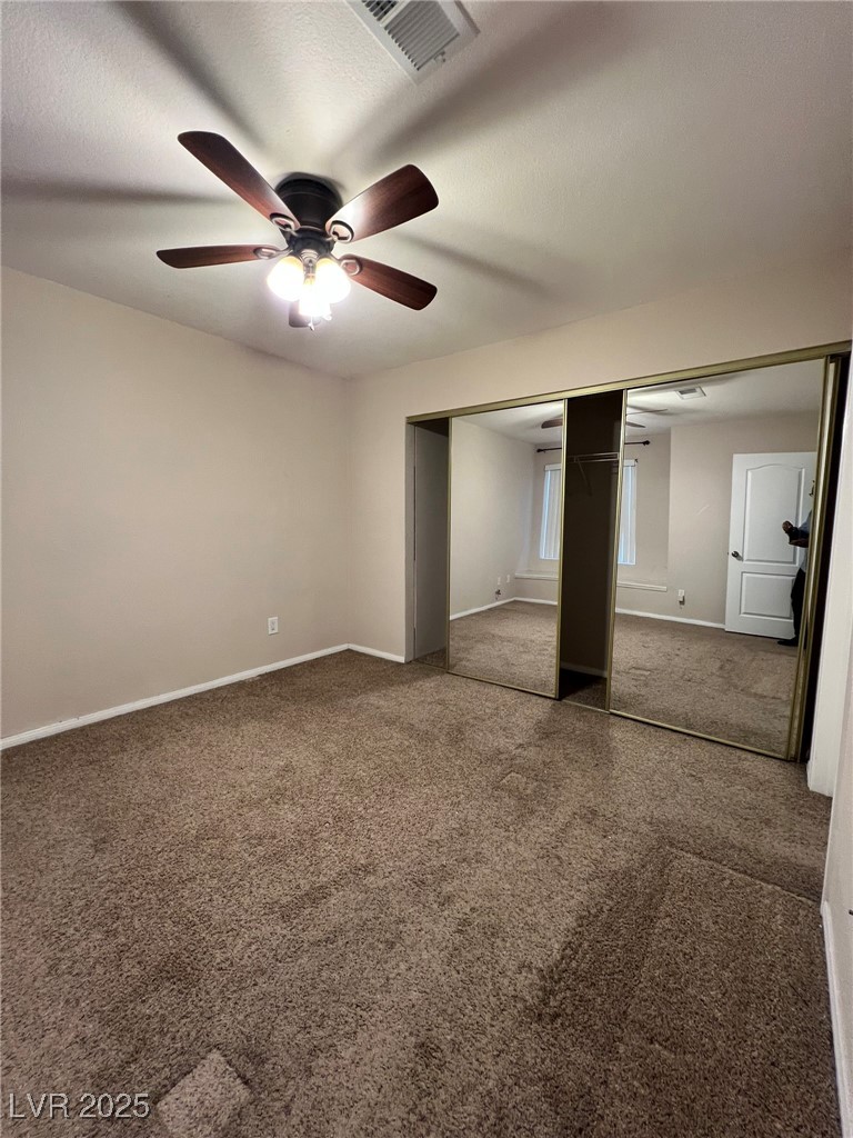 9325 West Desert Inn Road, Unit 206 Las Vegas, NV 89117 - Photo 22 of 37 Unfurnished bedroom featuring carpet floors, a closet, a ceiling fan, and a textured ceiling