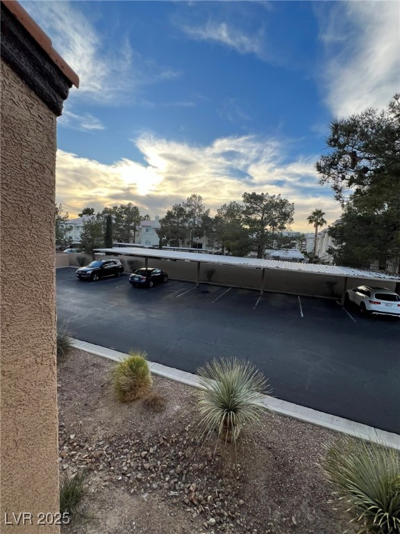 9325 West Desert Inn Road, Unit 206 Las Vegas, NV 89117 - Photo 26 of 37 Parking at dusk with covered parking