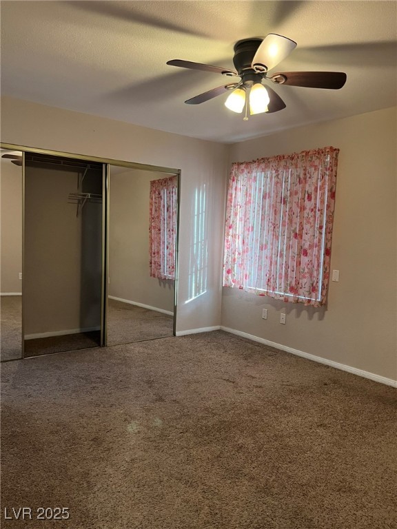 9325 West Desert Inn Road, Unit 206 Las Vegas, NV 89117 - Photo 8 of 37 Unfurnished bedroom with a closet, a ceiling fan, and carpet