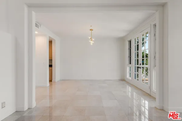 an empty room with windows and entrance