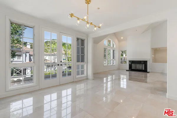 a view of livingroom with furniture flat screen tv and windows