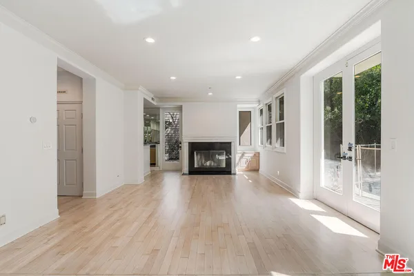 a view of a room wooden floor and a fireplace