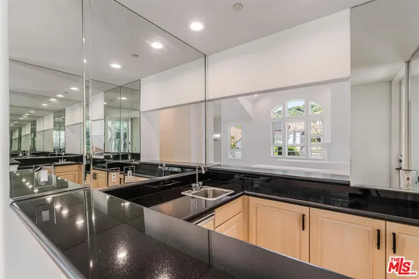 a kitchen with granite countertop a sink and a stove top oven