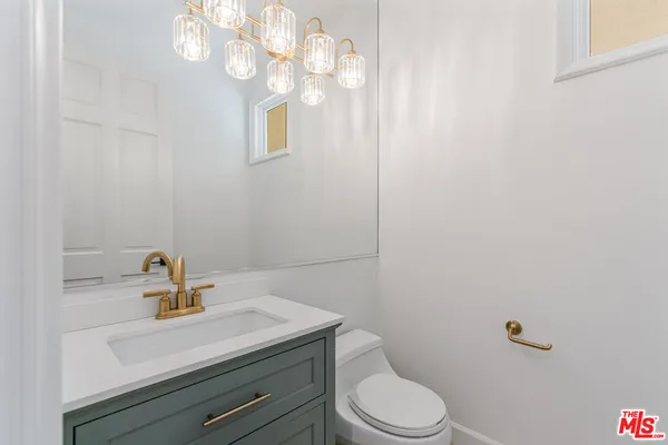 a bathroom with a sink a toilet and vanity