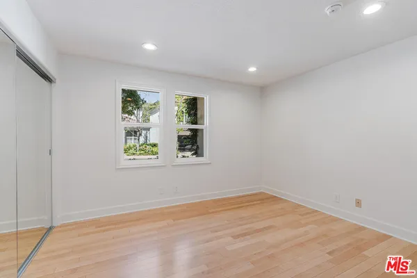 a bathroom with a sink a toilet a mirror a vanity and shower
