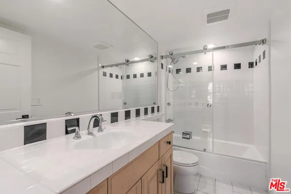 a view of an empty room with a cabinet and a window