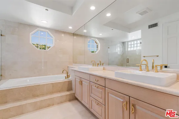 a bathroom with a bathtub and shower