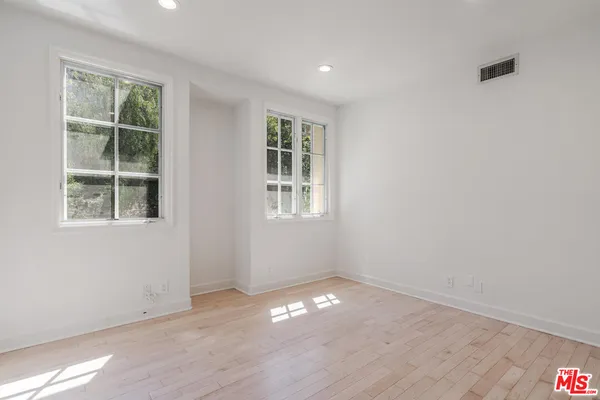 a bathroom with a double vanity sink window and two mirror