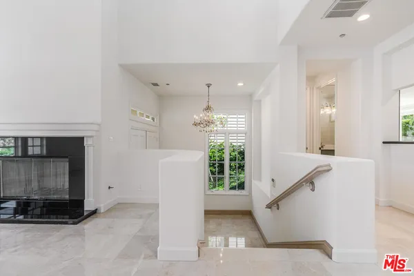 a view of entryway with kitchen and front door