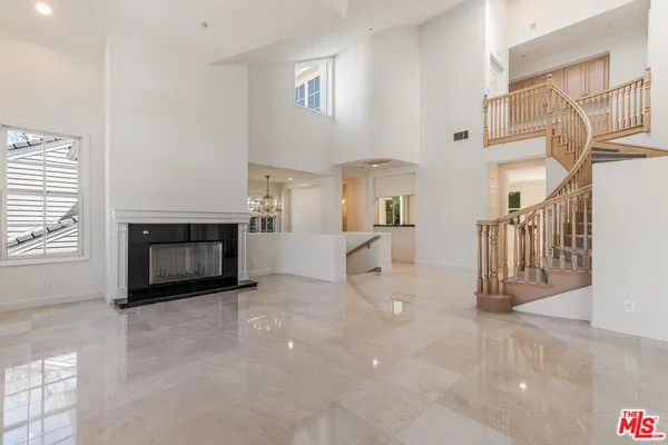 a view of a livingroom with a fireplace and window