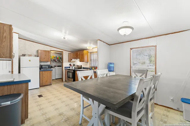a open kitchen with cabinets and stainless steel appliances