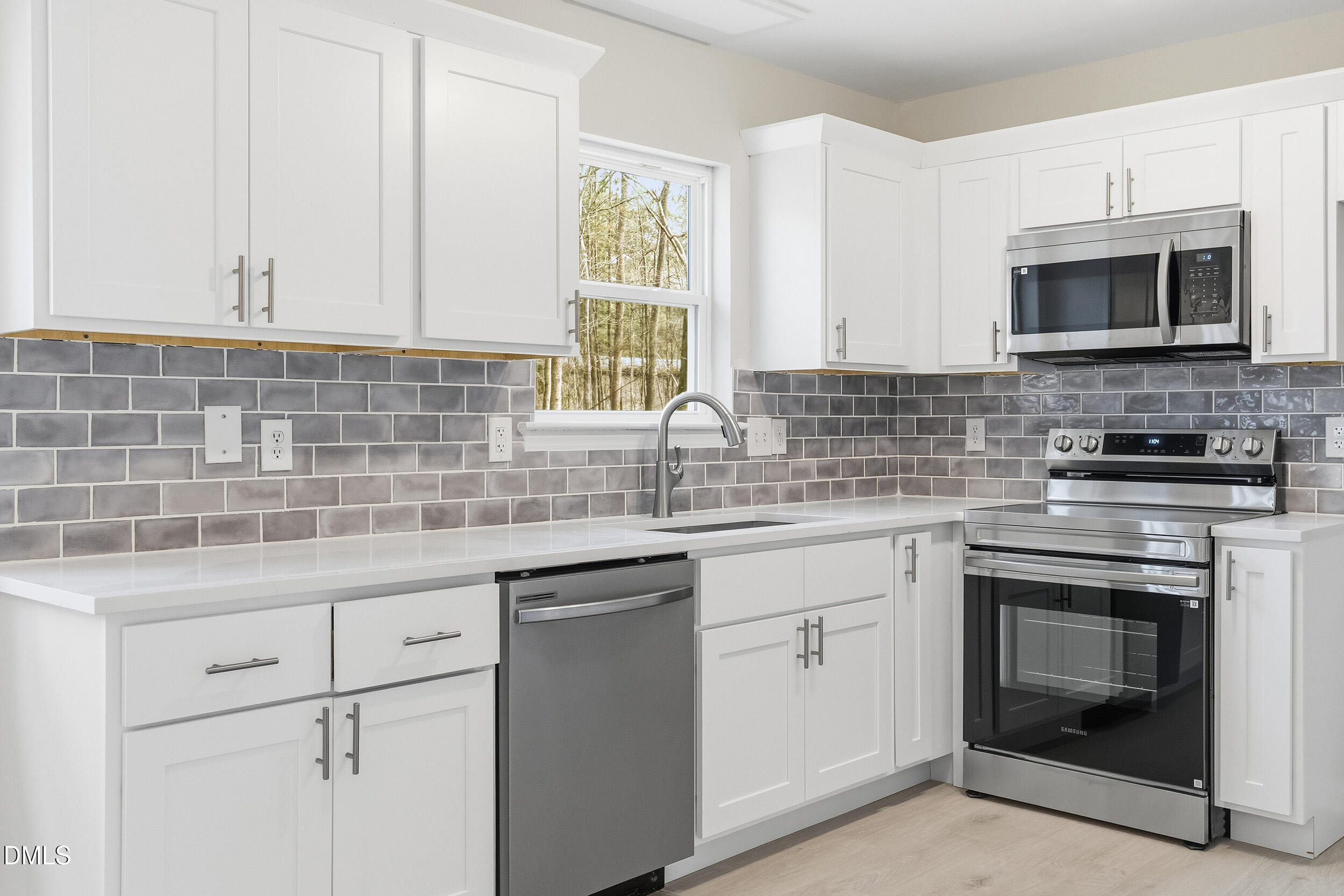 2020 Collier Road Durham, NC 27707 - Photo 1 of 32 a kitchen with white cabinets stainless steel appliances and sink
