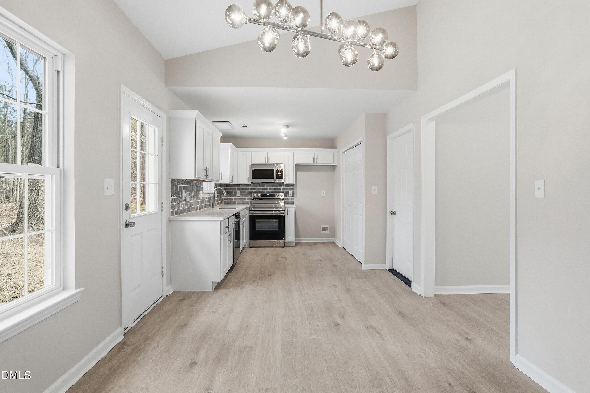 2020 Collier Road Durham, NC 27707 - Photo 11 of 32 a view of a kitchen with a sink cabinets and wooden floor