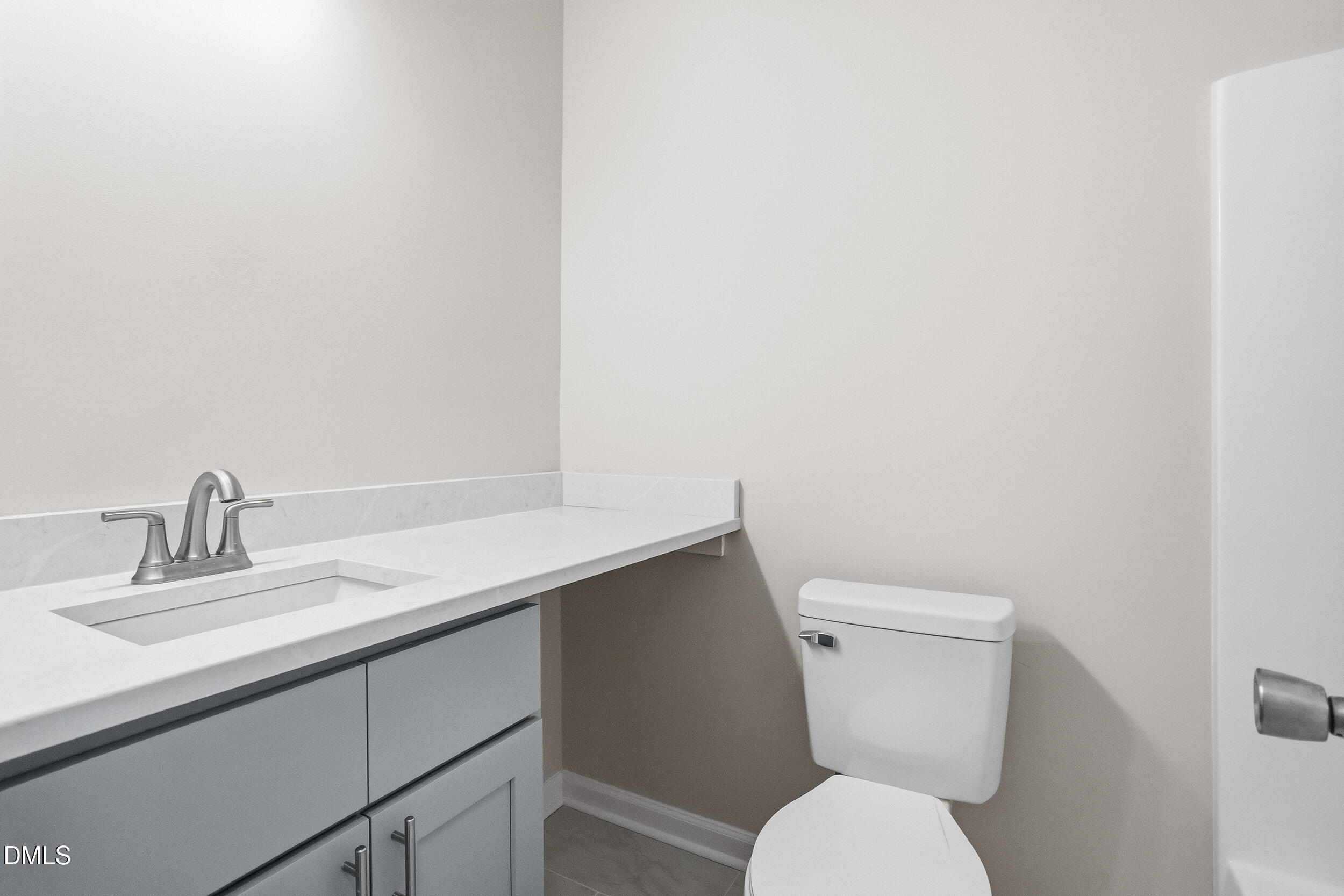 2020 Collier Road Durham, NC 27707 - Photo 23 of 32 a bathroom with a toilet a sink and mirror