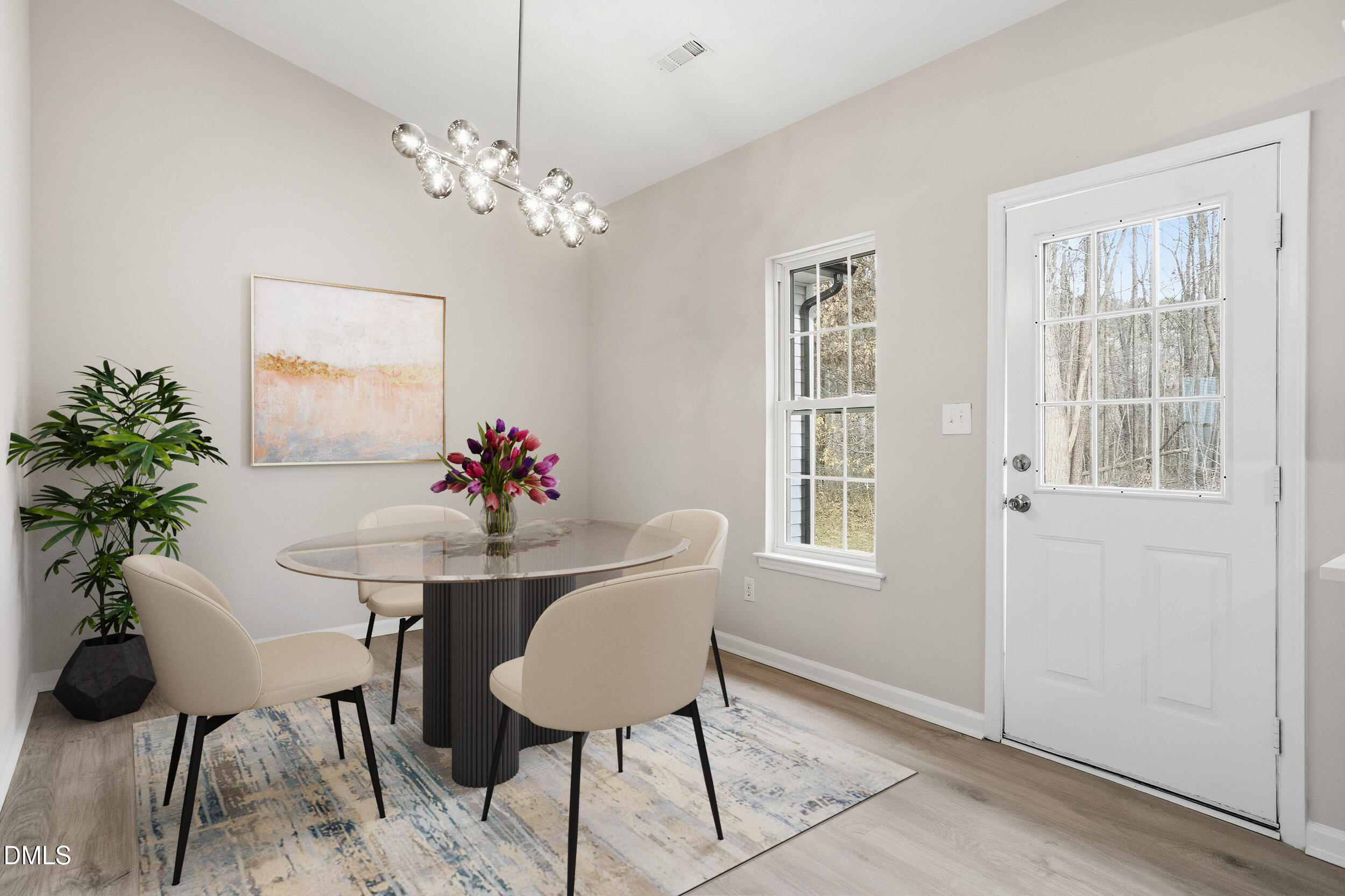 2020 Collier Road Durham, NC 27707 - Photo 5 of 32 a dining room with furniture potted plants and wooden floor