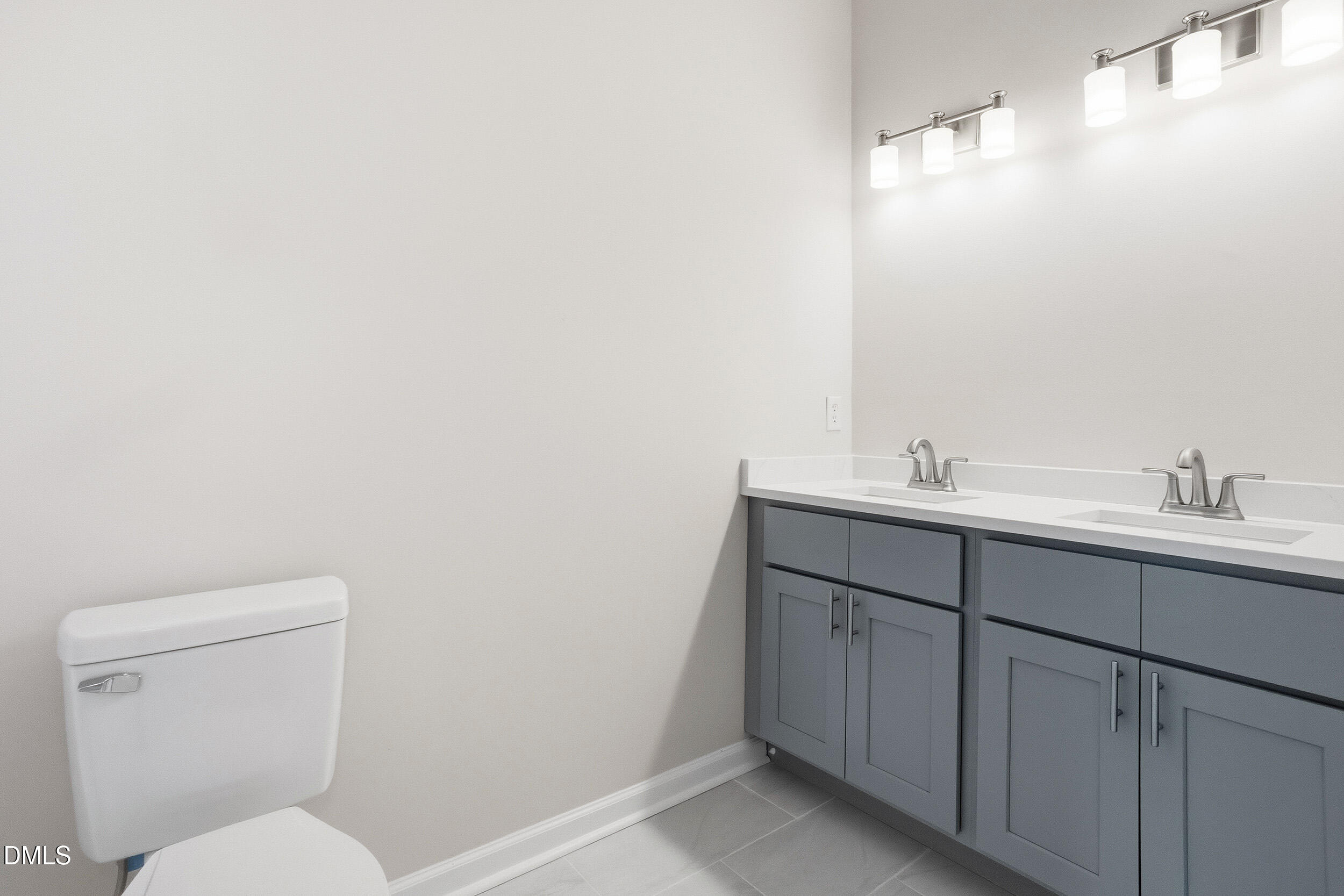 2020 Collier Road Durham, NC 27707 - Photo 7 of 32 a bathroom with a toilet sink and mirror