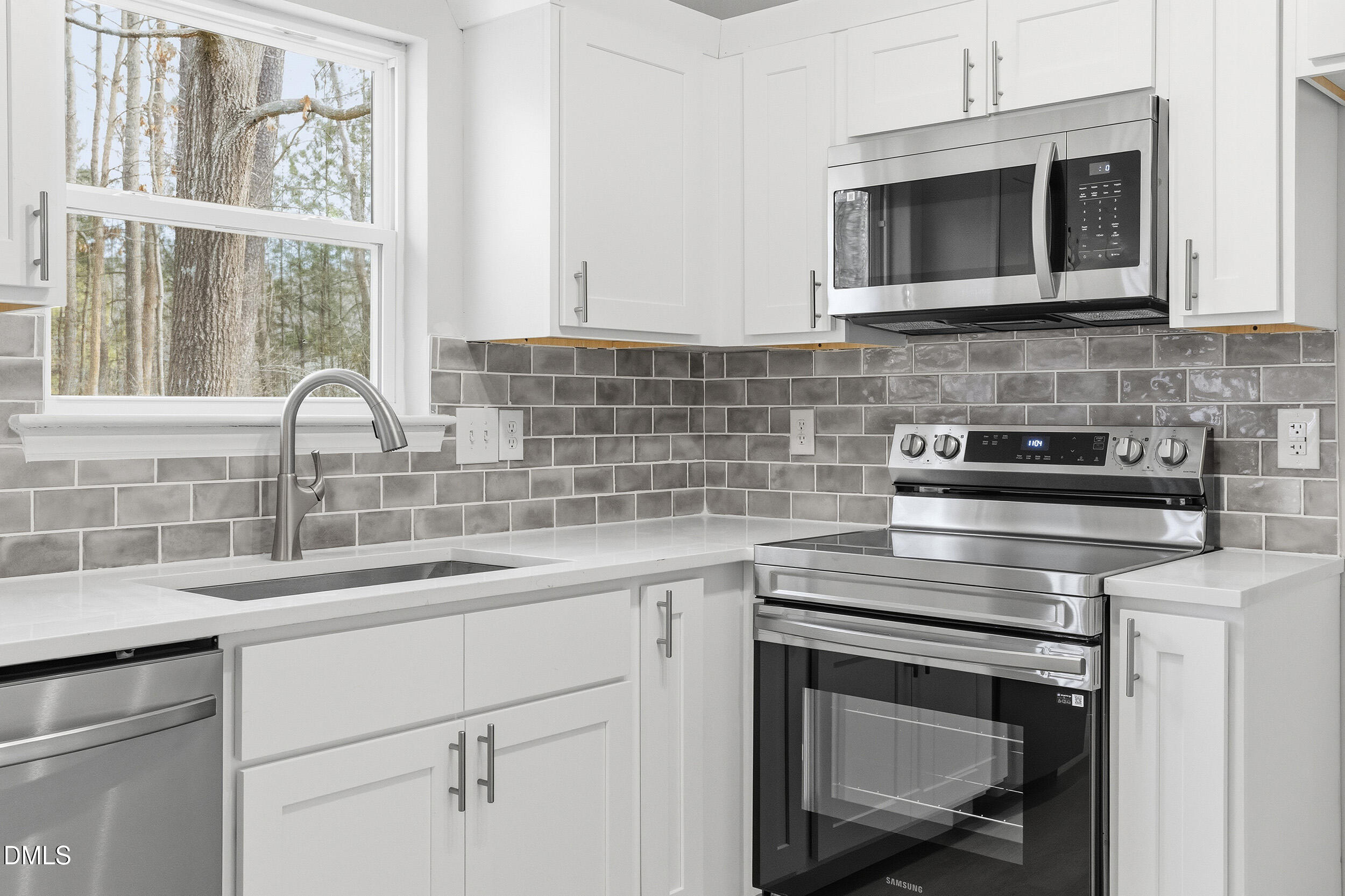2020 Collier Road Durham, NC 27707 - Photo 8 of 32 a kitchen with appliances a sink and cabinets