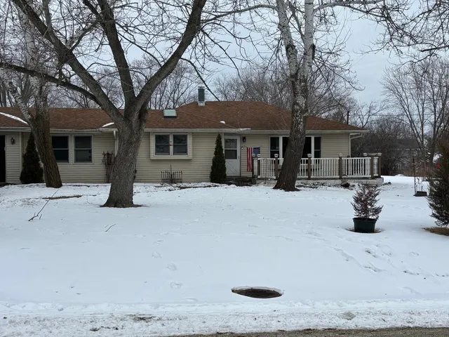 a view of a house with snow on the road