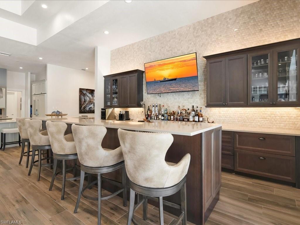 656 Hickory Road Naples, FL 34108 - Photo 14 of 50 a kitchen with a dining table chairs and white cabinets