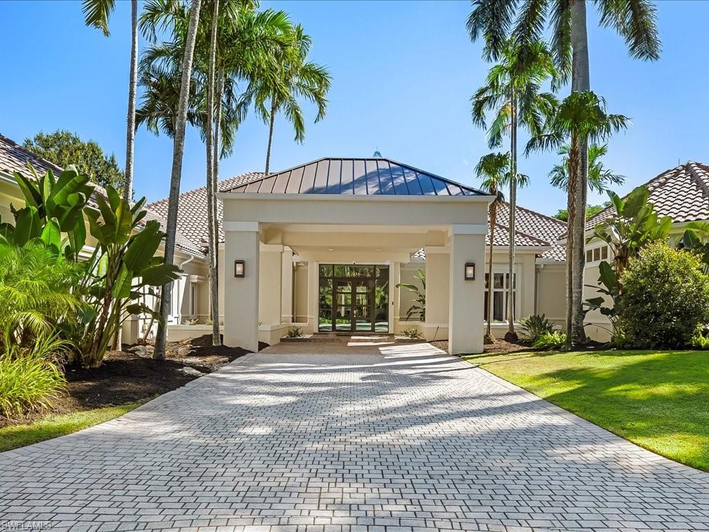 656 Hickory Road Naples, FL 34108 - Photo 2 of 50 a front view of a house with a garden