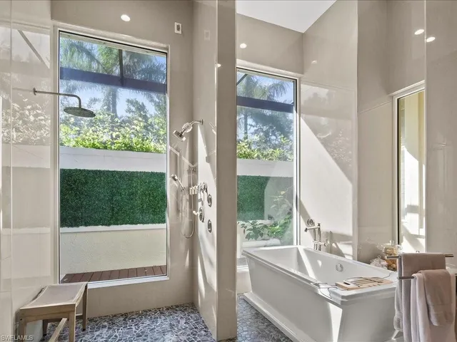 a bathroom with a sink mirror and a bathtub