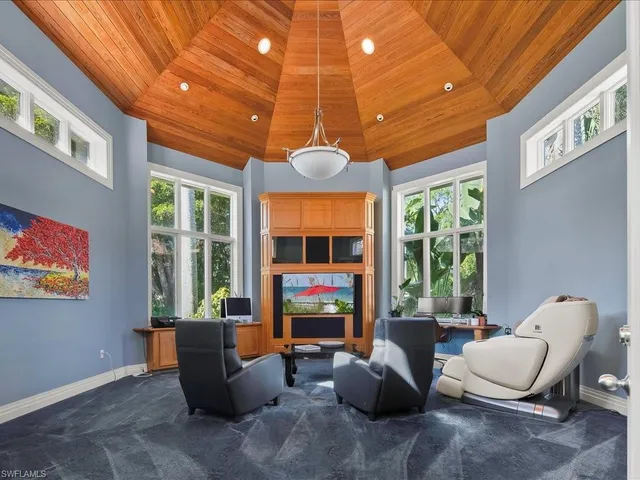 a living room with furniture a window and a flat screen tv