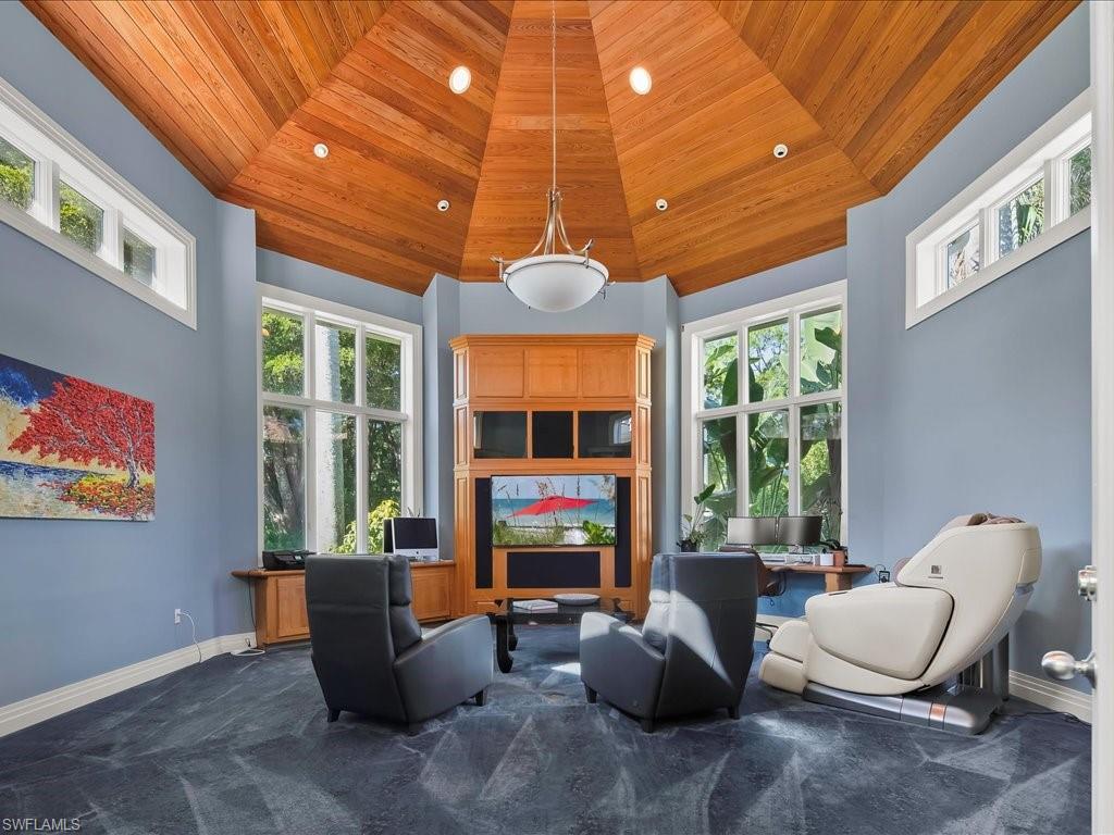 656 Hickory Road Naples, FL 34108 - Photo 23 of 50 a living room with furniture a window and a flat screen tv