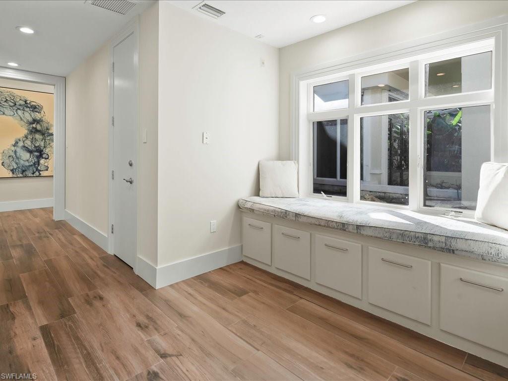656 Hickory Road Naples, FL 34108 - Photo 25 of 50 a bathroom with a sink and a large mirror