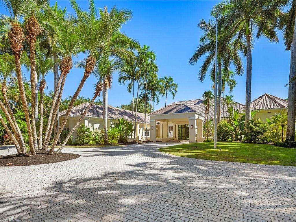 656 Hickory Road Naples, FL 34108 - Photo 3 of 50 a front view of a house with garden and trees