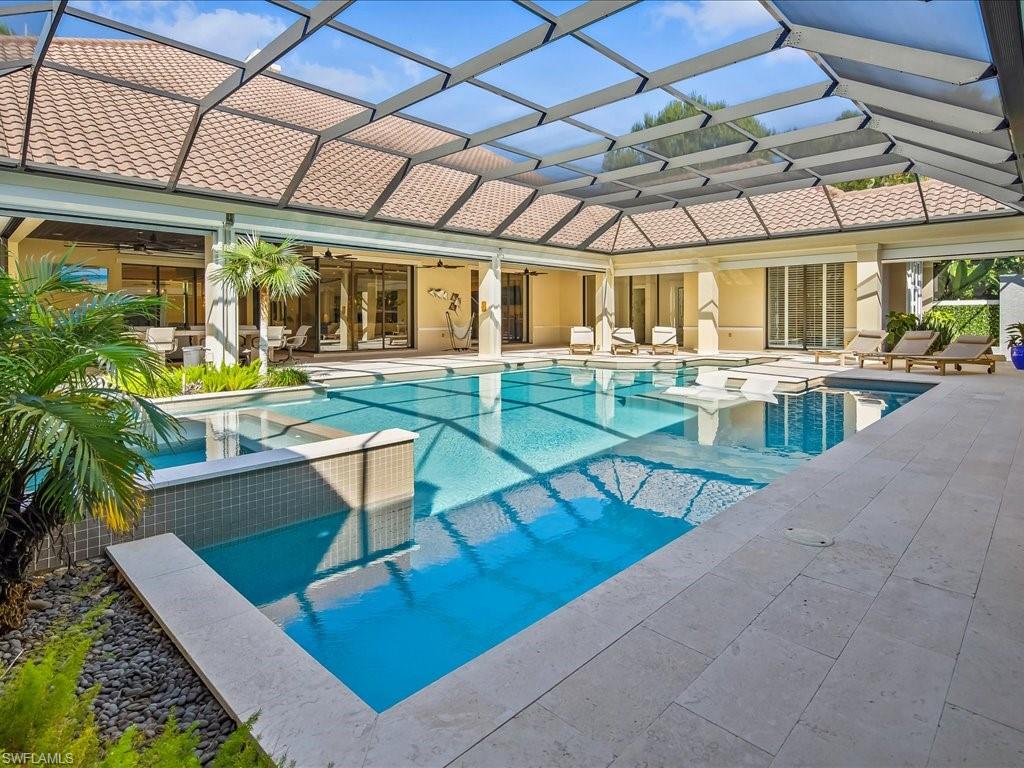 656 Hickory Road Naples, FL 34108 - Photo 31 of 50 a view of a swimming pool with outdoor seating
