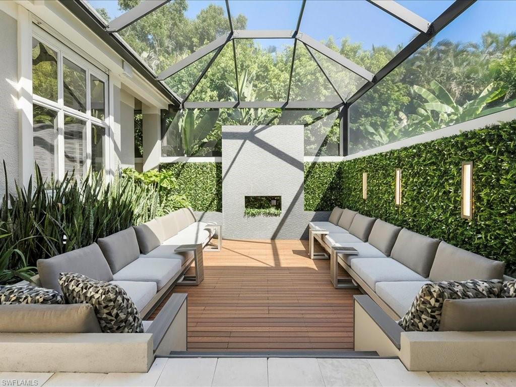 656 Hickory Road Naples, FL 34108 - Photo 33 of 50 a view of a patio with couches table and chairs