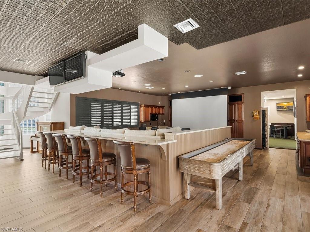 656 Hickory Road Naples, FL 34108 - Photo 37 of 50 a large kitchen with a table and chairs