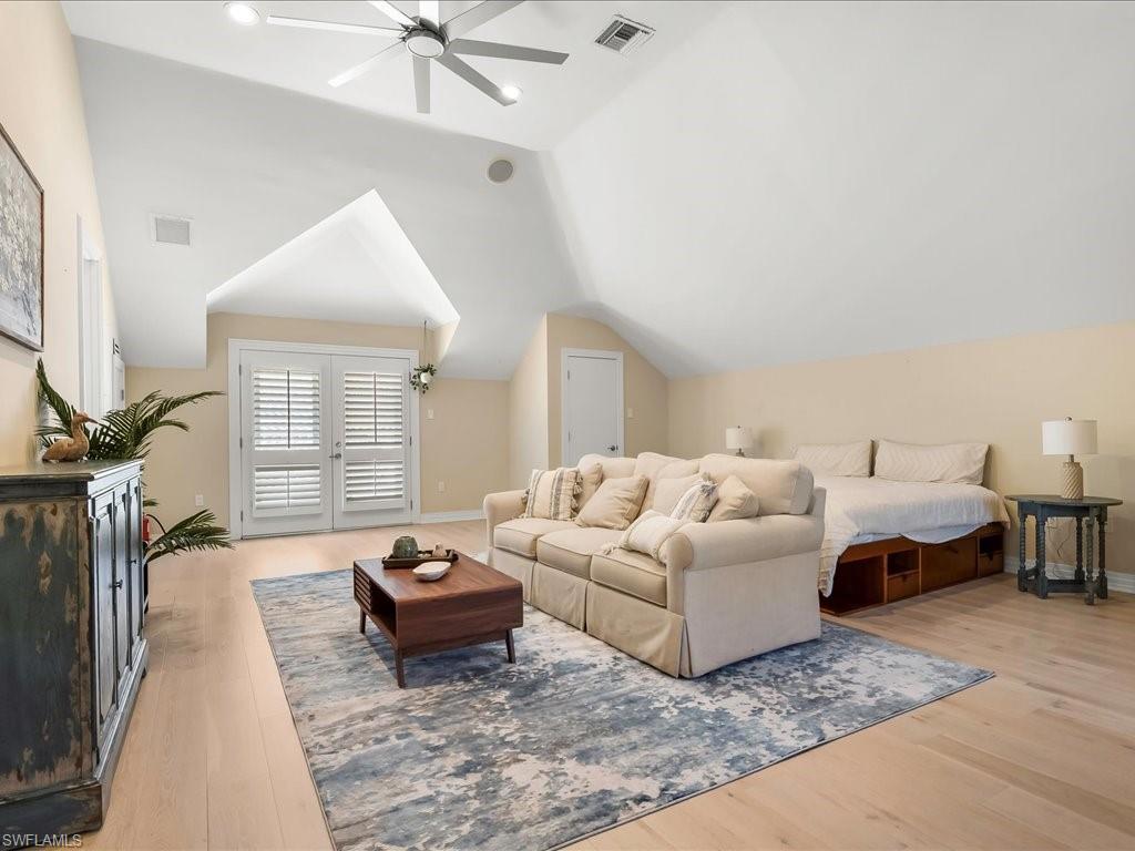 656 Hickory Road Naples, FL 34108 - Photo 39 of 50 a living room with furniture a rug and a chandelier