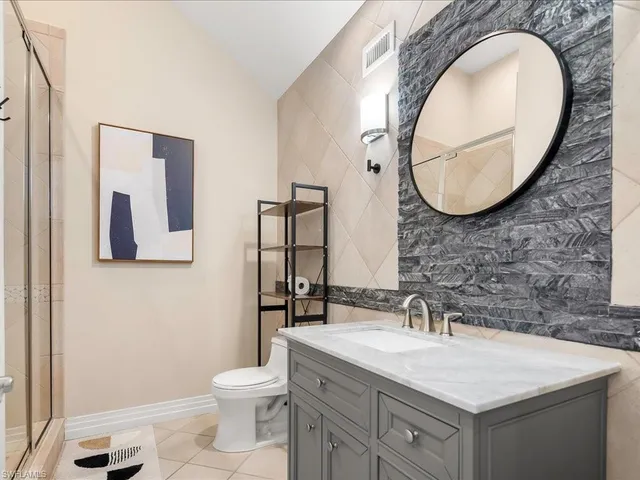 a spacious bedroom with a bed and a window