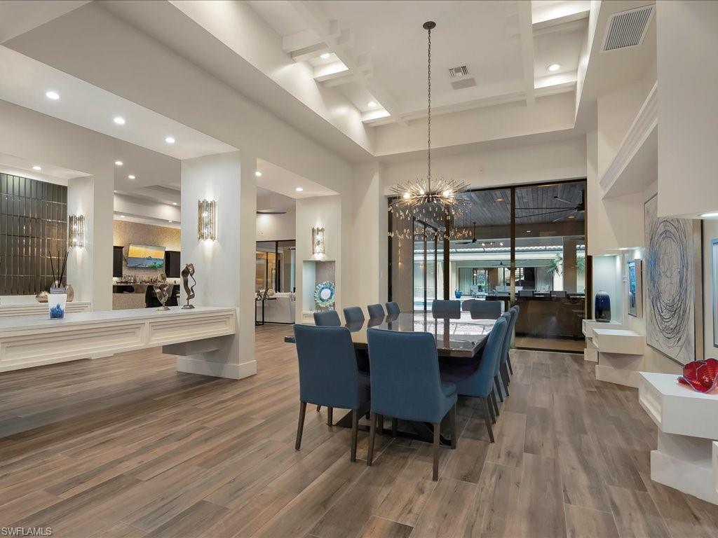 656 Hickory Road Naples, FL 34108 - Photo 44 of 50 a view of a dining room with furniture wooden floor and a chandelier