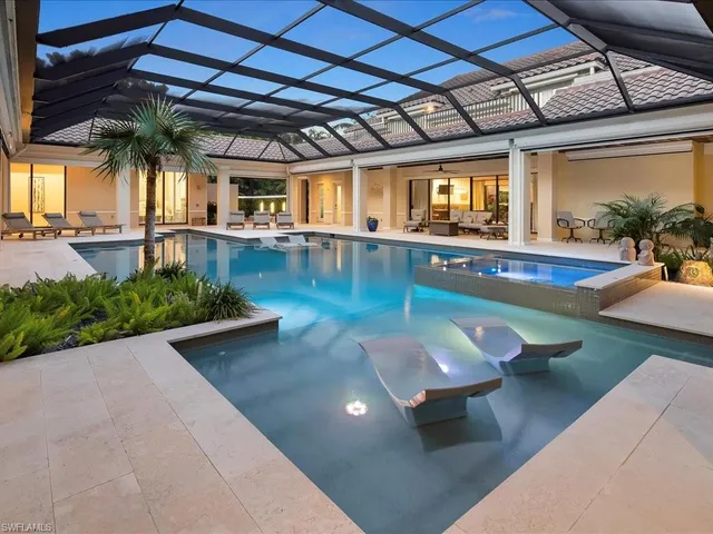 a view of a swimming pool with a outdoor seating