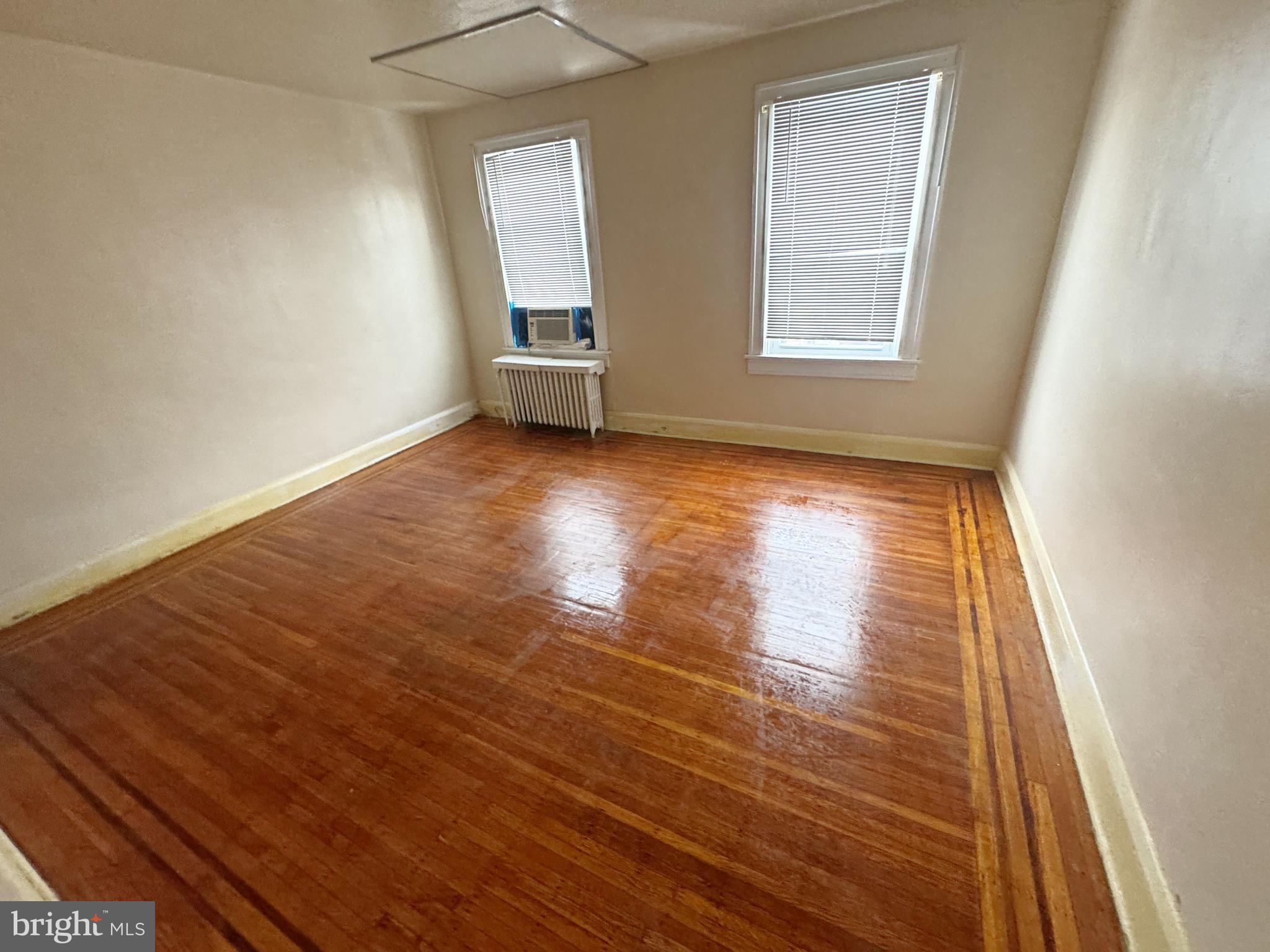 3323 Kenyon Avenue Baltimore, MD 21213 - Photo 12 of 20 an empty room with wooden floor and windows