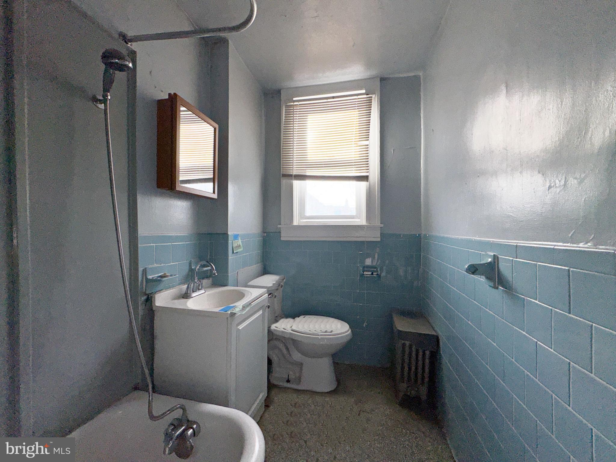 3323 Kenyon Avenue Baltimore, MD 21213 - Photo 15 of 20 a bathroom with a toilet sink and mirror